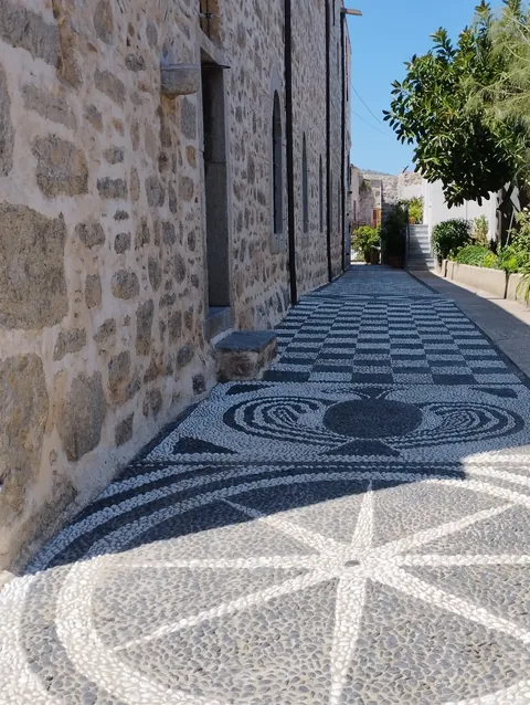 Patterned pebble paving — a visual thread woven through shared space